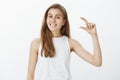 Small things makes me happy. Portrait of positive good-looking feminine girlfriend in white tank-top, raising hand and Royalty Free Stock Photo