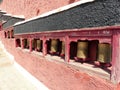 Small Tibetan prayer wheels aligned in Ladakh, India. Royalty Free Stock Photo