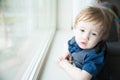 Small toddler boy gazing out Window Royalty Free Stock Photo