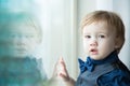 Small toddler boy gazing out Window Royalty Free Stock Photo