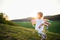 Small toddler girl playing on meadow outdoors in summer. Copy space. Royalty Free Stock Photo