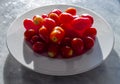 Small tomatoes in a white plate Royalty Free Stock Photo