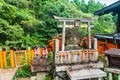 Small Torii Gates and foxes at the Fushimi Inari taisha, Kyoto, Honshu, Japan