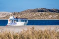 Small tour boat lying at the beach of Coral Bay close to sunset