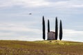 A small touring plane flies over the ancient Church of San Pierino in Camugliano, Ponsacco, Pisa, Italy Royalty Free Stock Photo