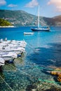 Small tourist boats for rent docked on the shore. Turquoise bay, crystal clear water. Amazing summer vacation on Royalty Free Stock Photo