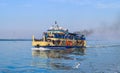 Small tourist ship with the passengers. Beautiful seascape with a tourist boat. The ferry just left the pier. Royalty Free Stock Photo