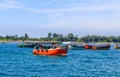 Small tourist ship with the passengers. Beautiful seascape with a tourist boat. The ferry just left the pier. Royalty Free Stock Photo