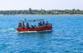 Small tourist ship with the passengers. Beautiful seascape with a tourist boat. The ferry just left the pier. Royalty Free Stock Photo