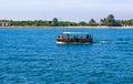 Small tourist ship with the passengers. Beautiful seascape with a tourist boat. The ferry just left the pier. Royalty Free Stock Photo