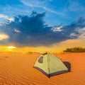 small touristic tent stay among sandy desert at the sunset