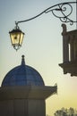 A small tower and a fishnet lantern shine through in the sun, against the backdrop of a blue sunset sky Royalty Free Stock Photo