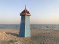 A small tower on the sea beach blue and red colors