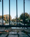 Small town canal with boats and cobblestone and bars in foreground Royalty Free Stock Photo