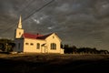 Small town church and cemetery with oncoming storm