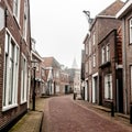 Small town Den Hoorn on the Texel island. Empty street in foggy morning. The Netherlands, Europe Royalty Free Stock Photo