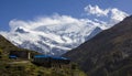 Small town of Ledar with its colorful buildings and the north face of the huge snow-capped Annapurna in the background. Annapurna Royalty Free Stock Photo