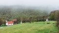 The small town between the mountains. Morning. Fog. Mist. Smog. Montenegro village houses and green landscape