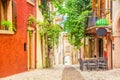 Small town narrow street view with colorful houses in Malcesine, Italy during sunny day. Beautiful lake Garda. Royalty Free Stock Photo