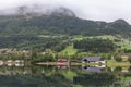 Small town in Norwegian fjord is beautifully reflected in the water, selective focus Royalty Free Stock Photo