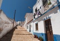 Small town in south Portugal with narrow streets and white houses under blue sky. Sunny village of Algarve region Royalty Free Stock Photo