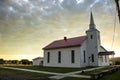 Small town church and cemetery with sun lite clouds