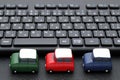 Small toy car on computer keyboard