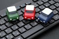 Small toy car on computer keyboard