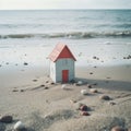 a small toy house on a beach