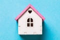 Small toy house on a blue background, top view