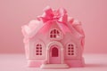 Small toy house decorated with pink bow on a pink background Royalty Free Stock Photo