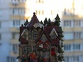 Small toy house with people figurines on a modern apartment house on background Royalty Free Stock Photo