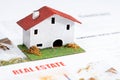 Small toy house on real estate documents. Royalty Free Stock Photo