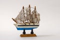 Small toy ship with sails on a white background. Royalty Free Stock Photo