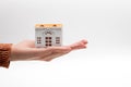 Small toys house on woman hand. Mortgage concept by house in hand