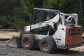 Small tractor with bucket. White tractor on four wheels. Royalty Free Stock Photo