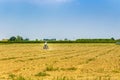 Small tractor plowing a large field