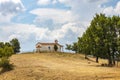 Small traditional Greek orthodox church on top of the hill against beautiful summer clouds Royalty Free Stock Photo