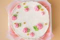 Small traditional Korean style bento cake with white cream cheese frosting decorated with pink whipped cream flowers. Little Royalty Free Stock Photo