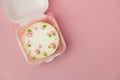 Small traditional Korean style bento cake with white cream cheese frosting decorated with pink whipped cream flowers. Little Royalty Free Stock Photo