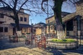 Small traditional paved square with cafe and authentic narrow streets in Nissaki, Ioannina.
