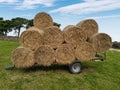 A trailer packed with hay bails on the farm isolated