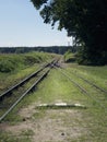 Small train station on narrow gauge. Village train station. Railroad tracks, railway traffic signs. Royalty Free Stock Photo