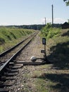 Small train station on narrow gauge. Village train station. Railroad tracks, railway traffic signs. Royalty Free Stock Photo