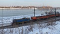 A small train travels on rails along the Angara River in Irkutsk.
