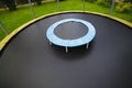 Small trampoline on big one with round mat, size comparison Royalty Free Stock Photo