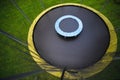 Small trampoline on big round mat, size comparison, green lawn background Royalty Free Stock Photo