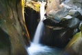 Small tranquil waterfall among the rocks of mountain creek Royalty Free Stock Photo