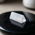 Small translucent prism with a triangular shape resting on a Royalty Free Stock Photo