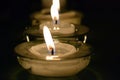 Small transparent glass candlesticks with small white candles